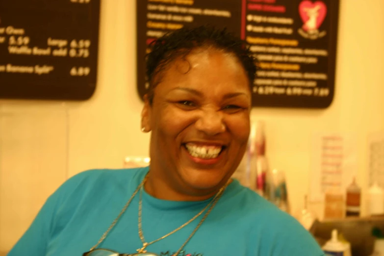 a woman laughing wearing a necklace and necklace