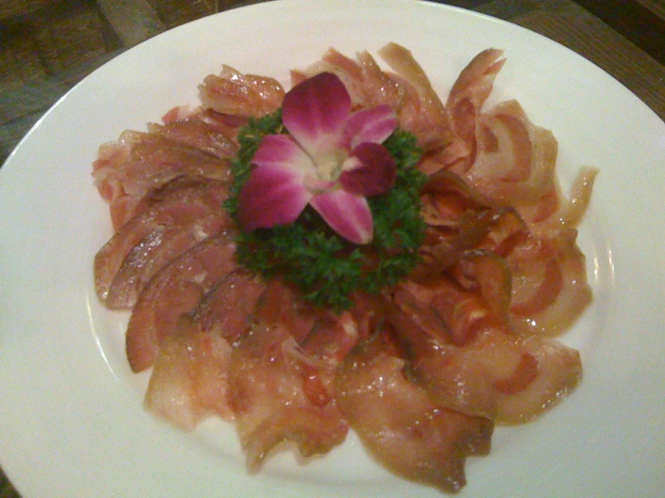 the dish is decorated with flowers and fish