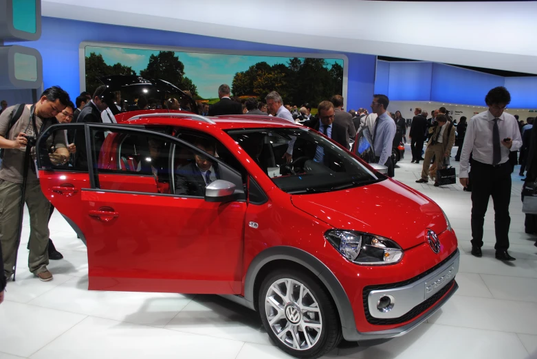 a small car is shown on display at an automobile show