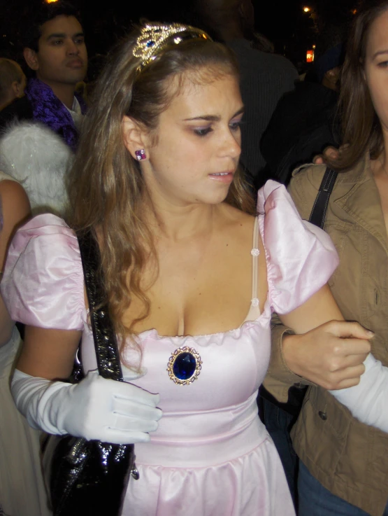 a woman dressed as a fairy standing next to people