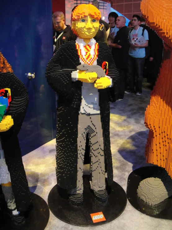 two lego sculptures of a man and woman standing next to each other