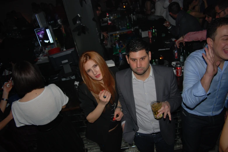 a group of people standing around with drinks