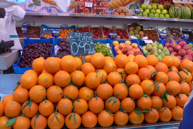 piles of oranges in a produce market display