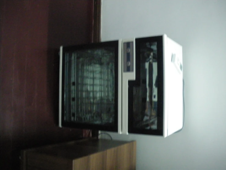 there is a very small tv with some glass inside