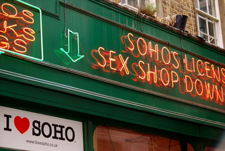 bright neon signs on the outside of a shop