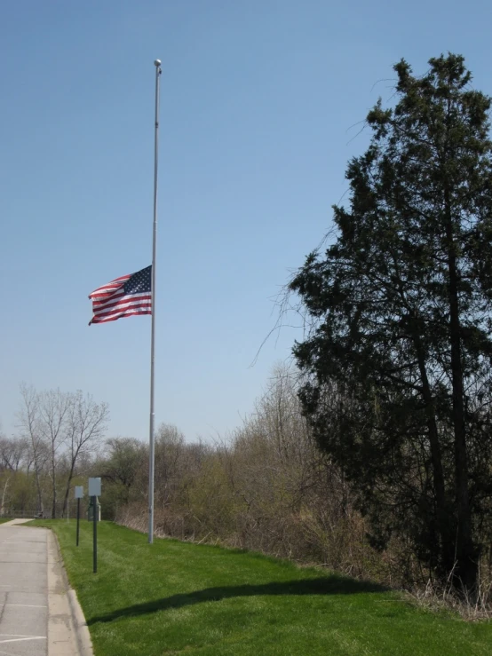 an american flag is seen on the top of a hill
