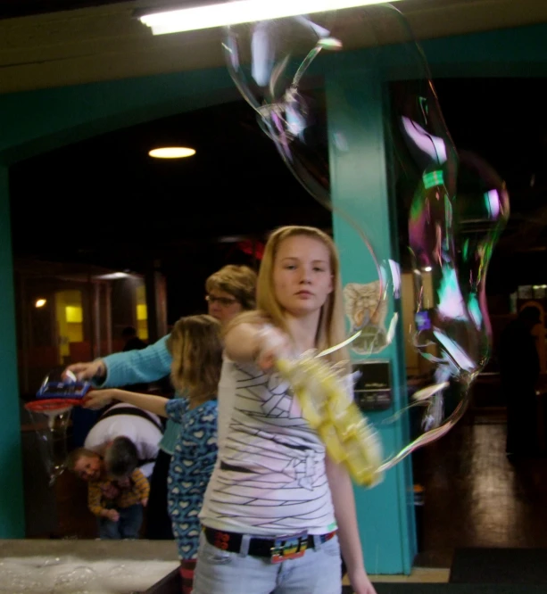 woman blowing bubbles in an art center