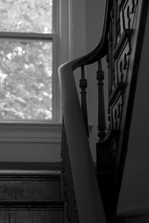 black and white image of staircase railing in room