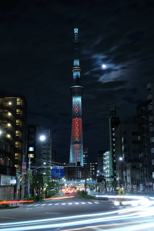 a tall tower with a clock on it sitting behind a busy street