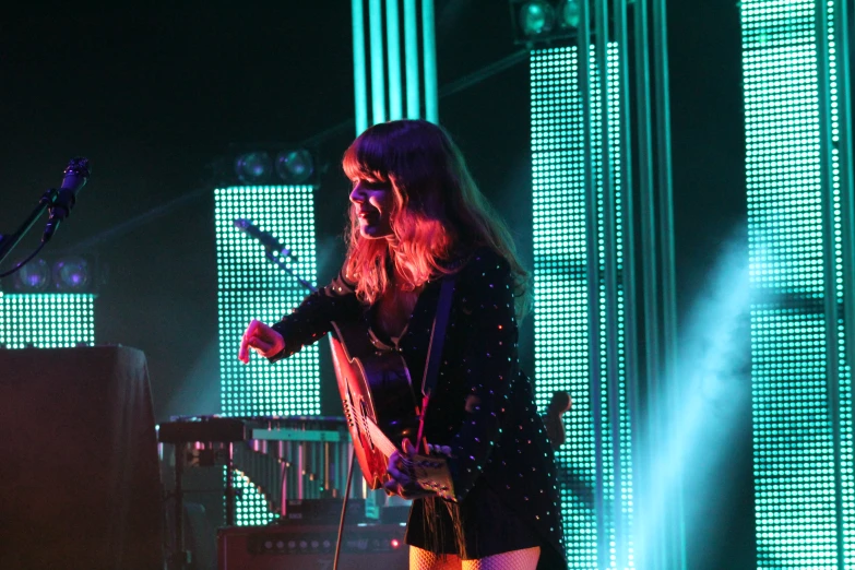 a female in tights standing next to a microphone