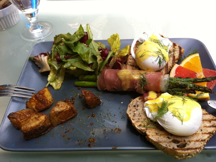 plate of food including an egg, bread and salad