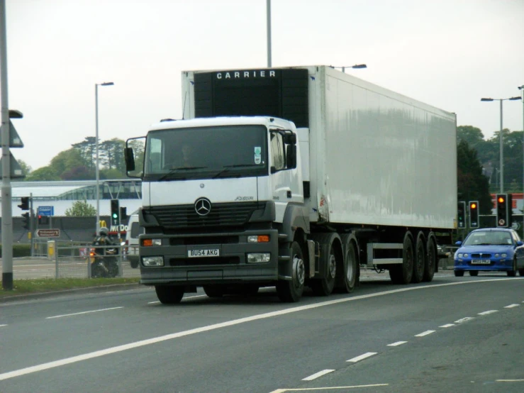 large truck driving down the highway next to traffic