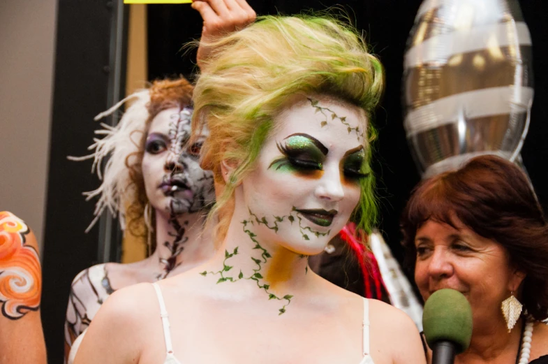 a person that has green hair and makeup