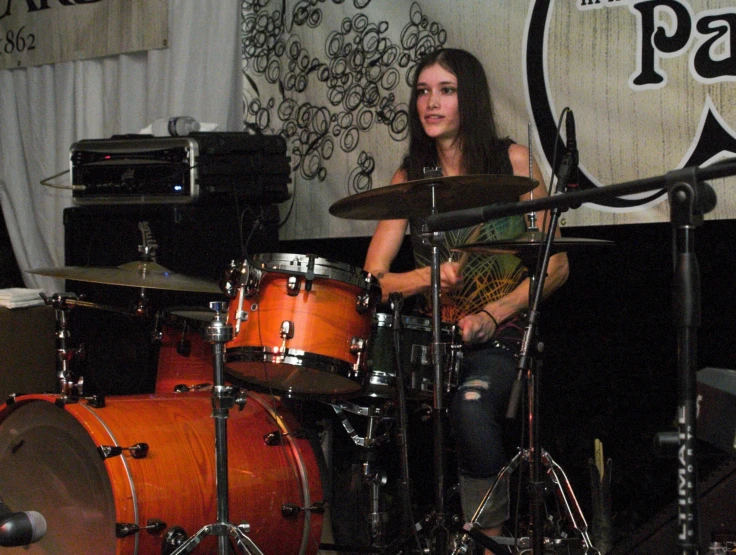 a person on a stage with some drums