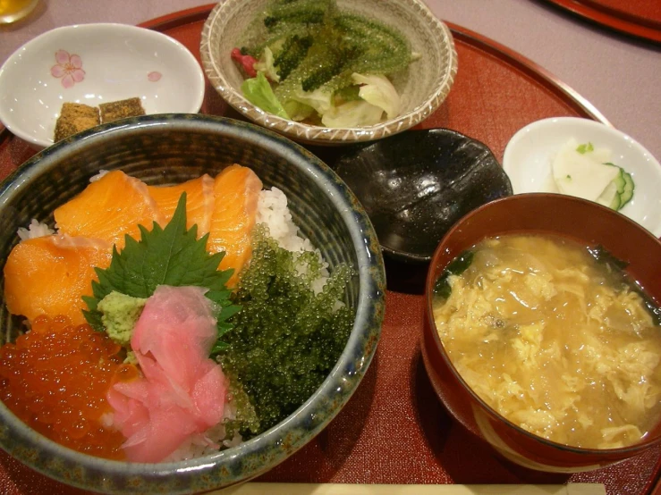 various bowls of food are set out on the table