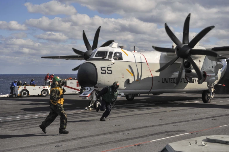 a small airplane is being boarded onto a ship