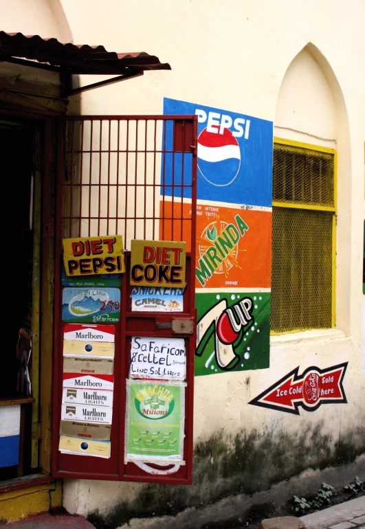 a wall in front of a building with several posters