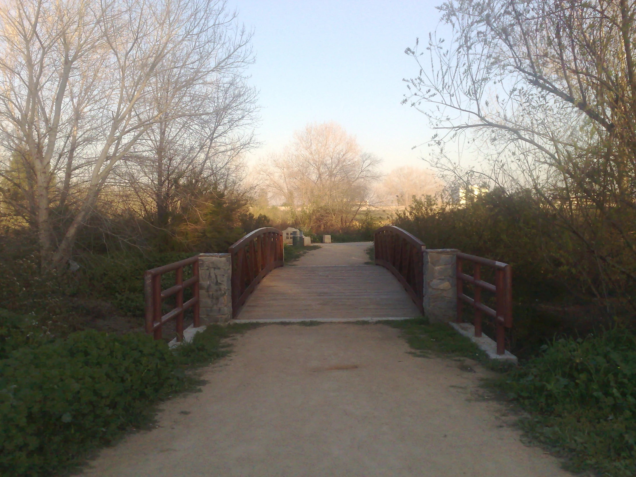 a walkway in the woods leading to an outdoor area