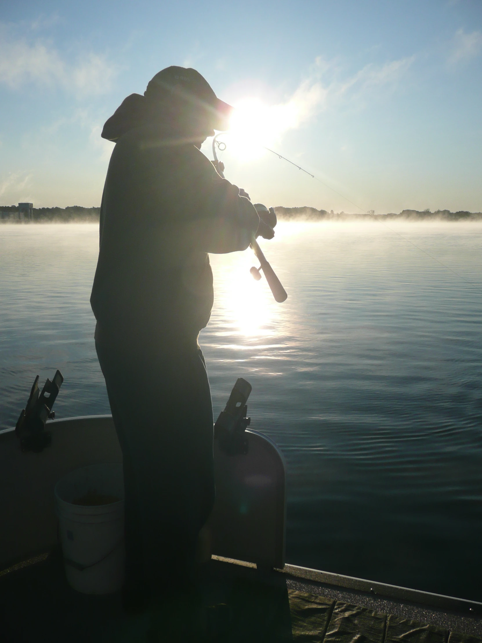 person on fishing boat holding onto a handle