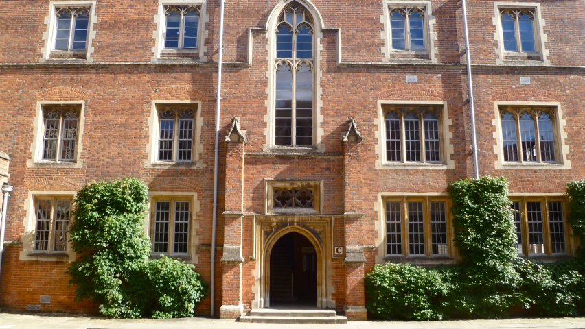 an old brick building with windows and stone steps