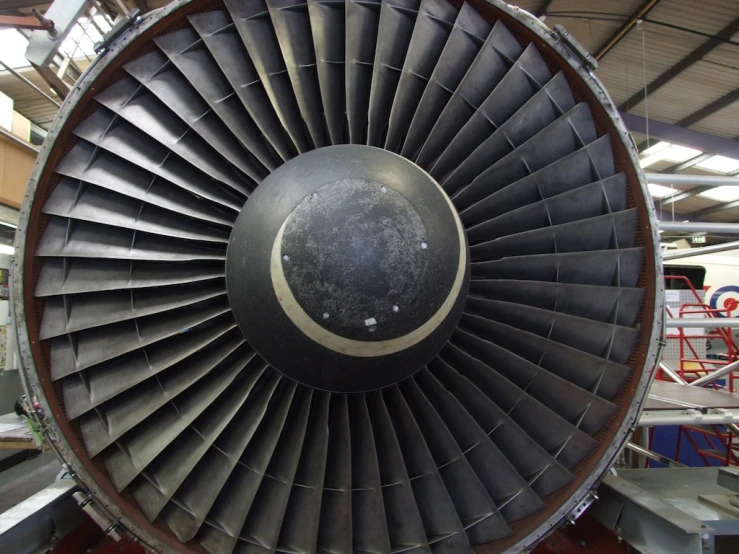 an airplane engine sitting inside of a hangar