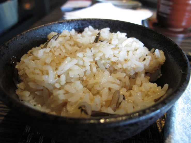a close up of rice in a bowl on a table