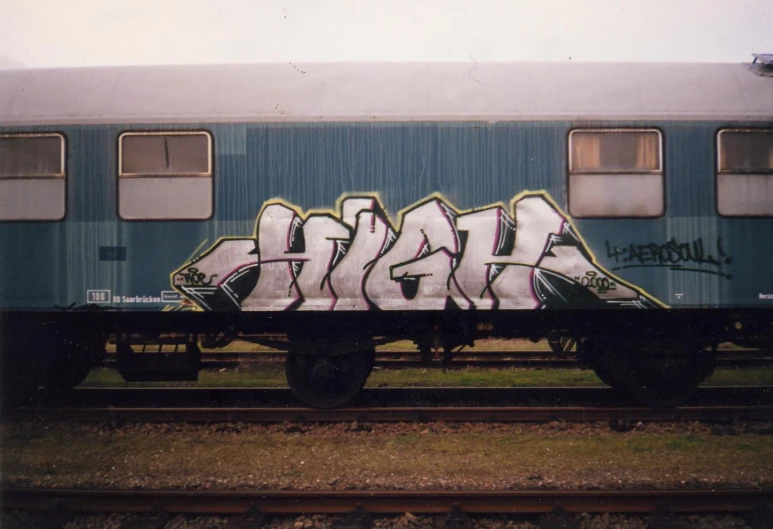 a picture of graffiti written on the side of train cars