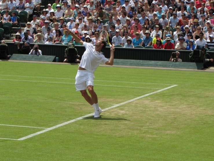 a man hitting a tennis ball with a racket