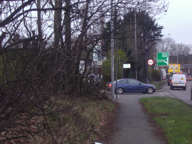 an open roadway leading into a city with lots of signs and trees