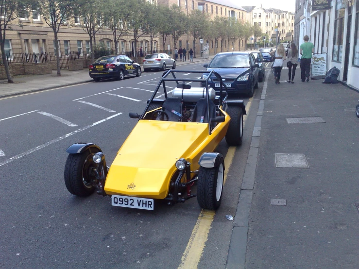 some cars and a motorcycle on a street