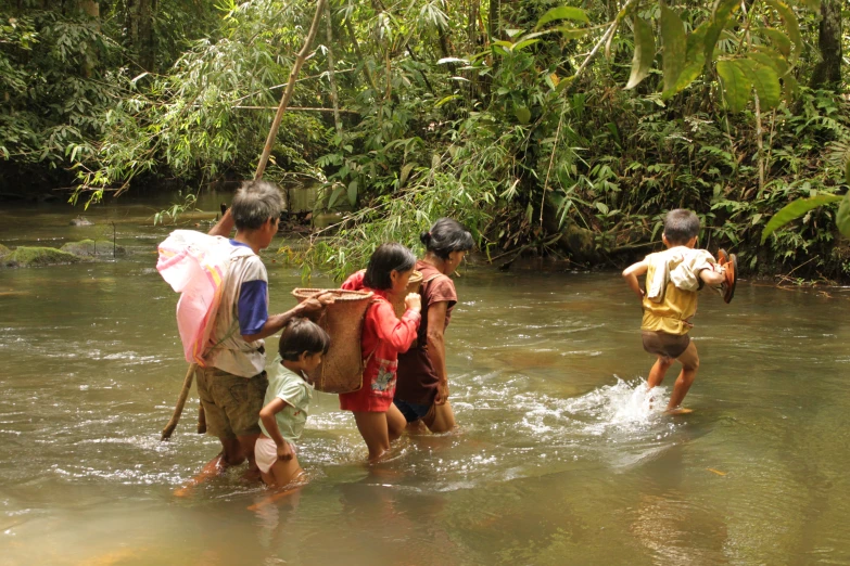 a group of children playing in some water