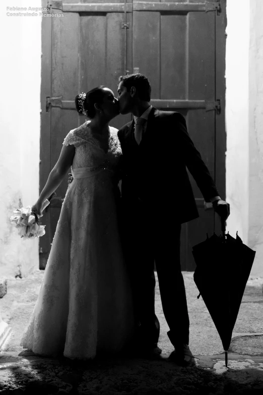 this is a wedding picture of two people that are kissing