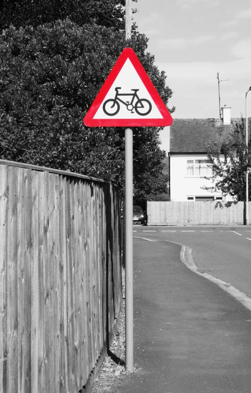 a sign warns drivers that the bike is on the street