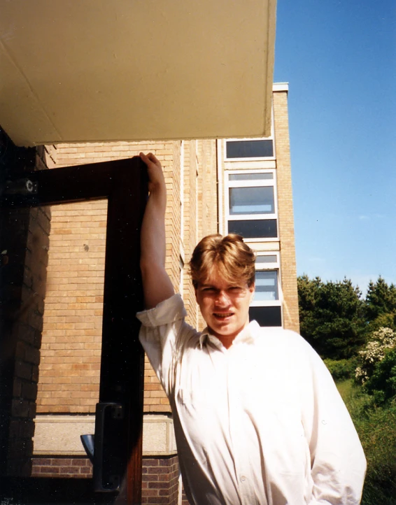 a woman is holding on to a building