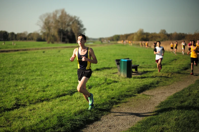 a runner crosses a path in a cross country race