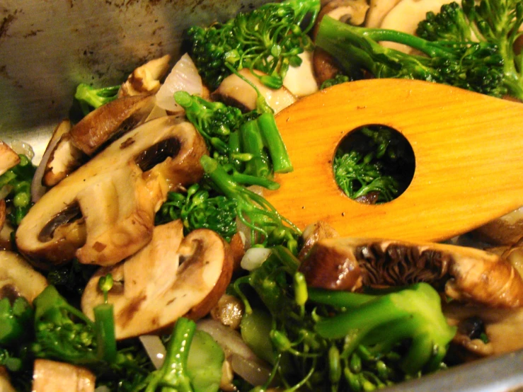 a vegetable stir fry in an aluminum wok