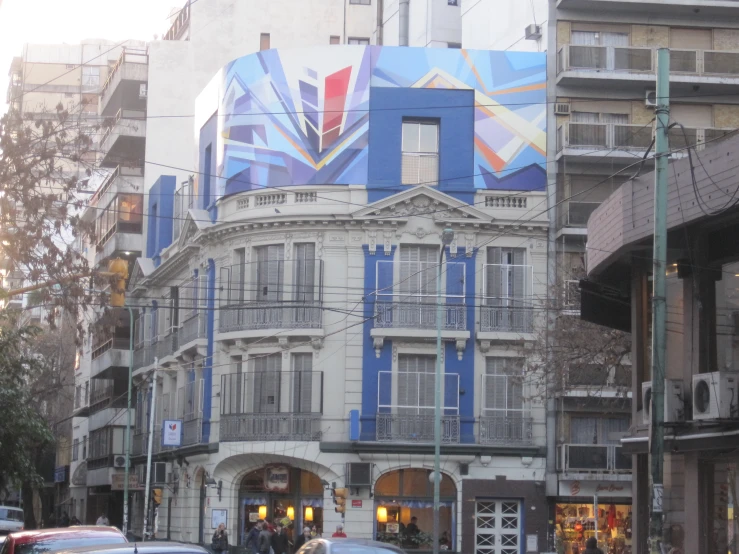 this is an old building with an interesting mural painted on it