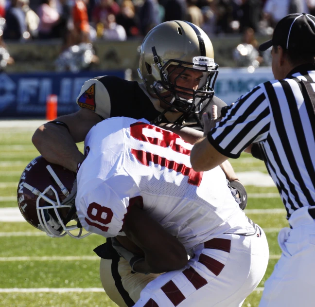 a football player that is holding onto another player