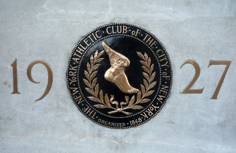 a plaque on a wall with gold lettering