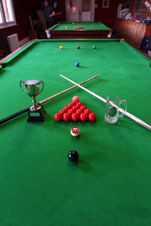 a pool table and various cues and billiards