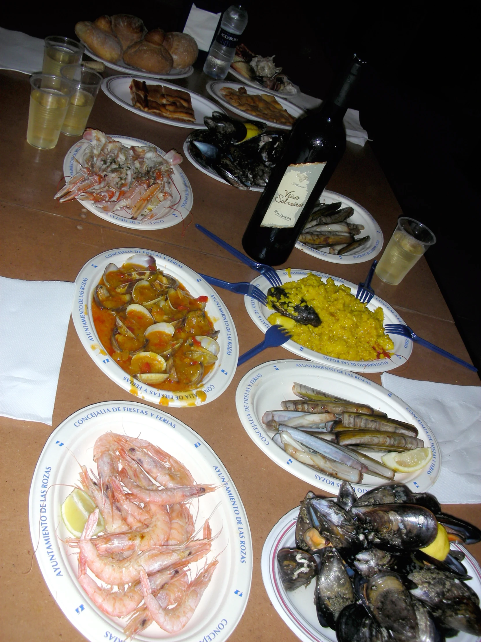 many plates of different foods and drinks are laid out on a table