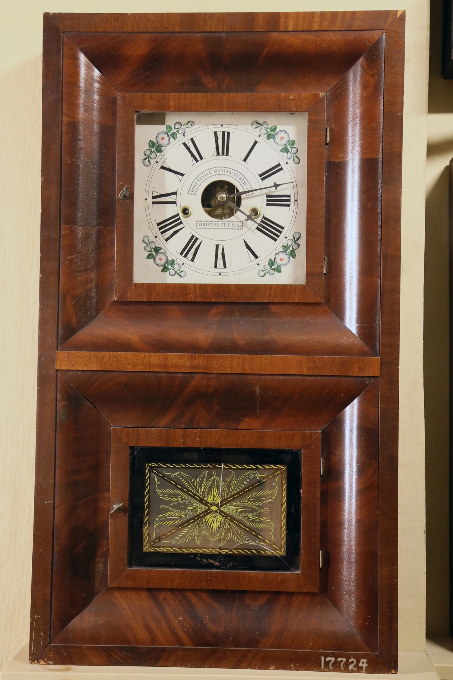 a brown and white clock sitting inside of a wall