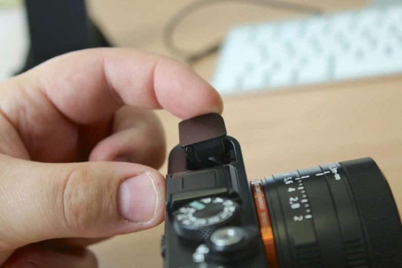 the hand is holding up an object in front of a camera