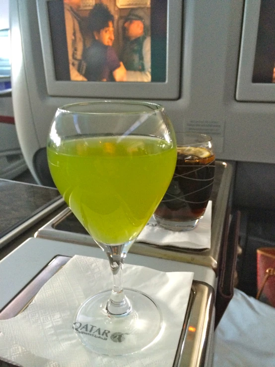 two drinks that are sitting on the edge of an airplane