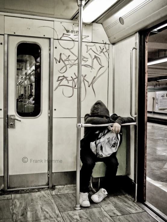 a man sitting on the subway and eating his lunch