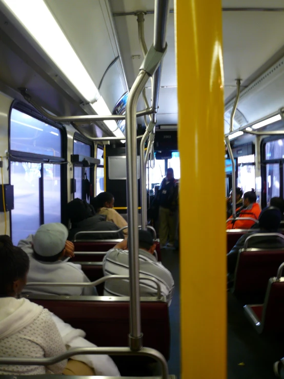 people are sitting in the train, on seats