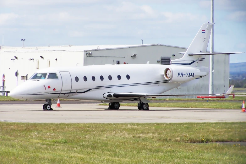 a small white airplane parked at the airport