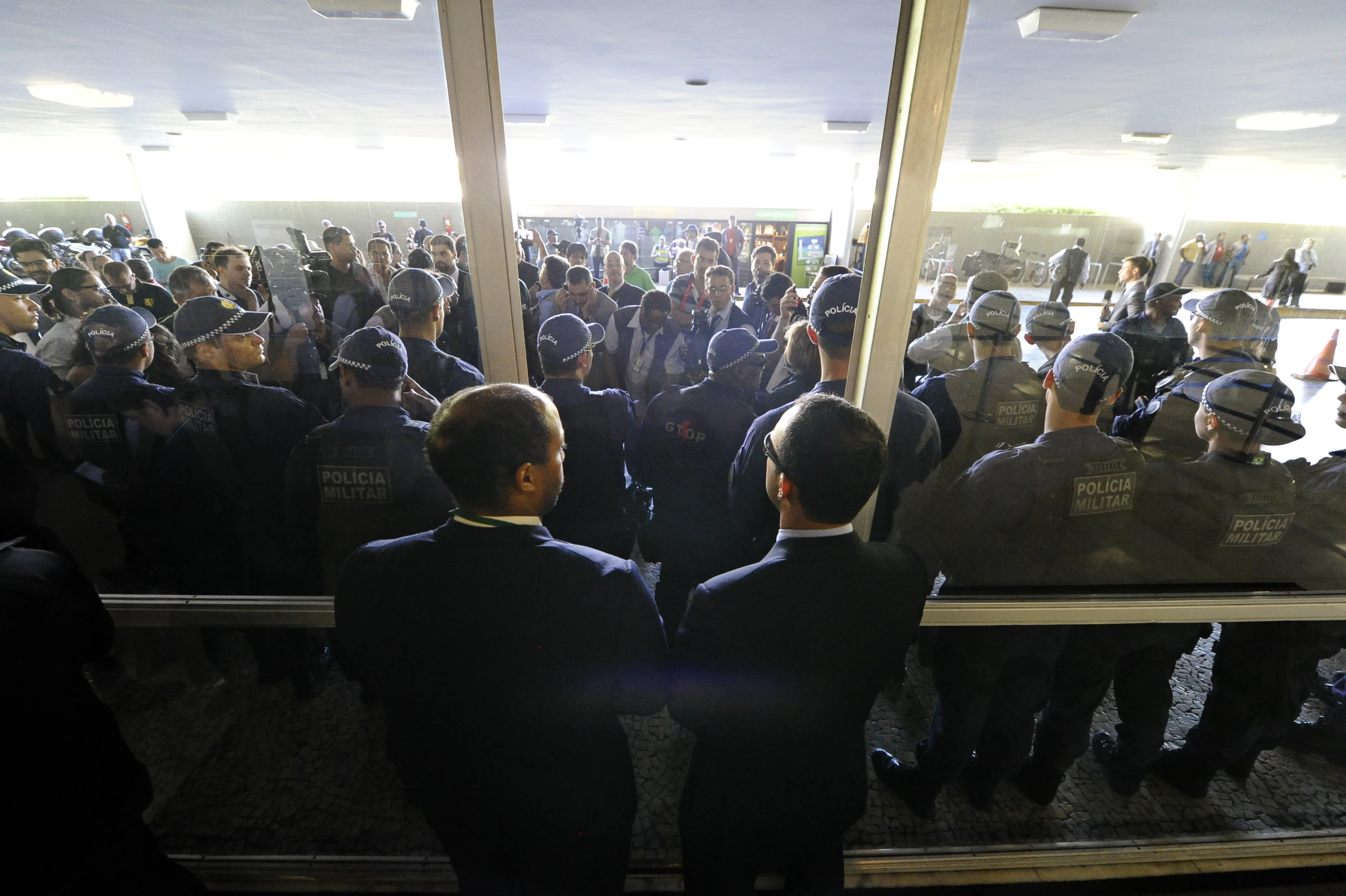 people line up to enter a courthouse waiting for their turn