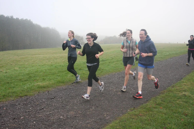 a group of people jogging on a path