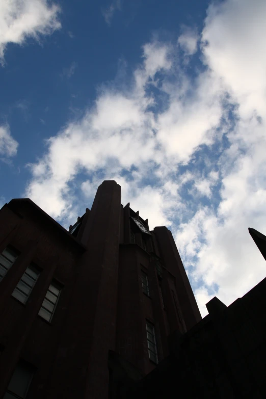 the building appears to be very tall and is surrounded by clouds